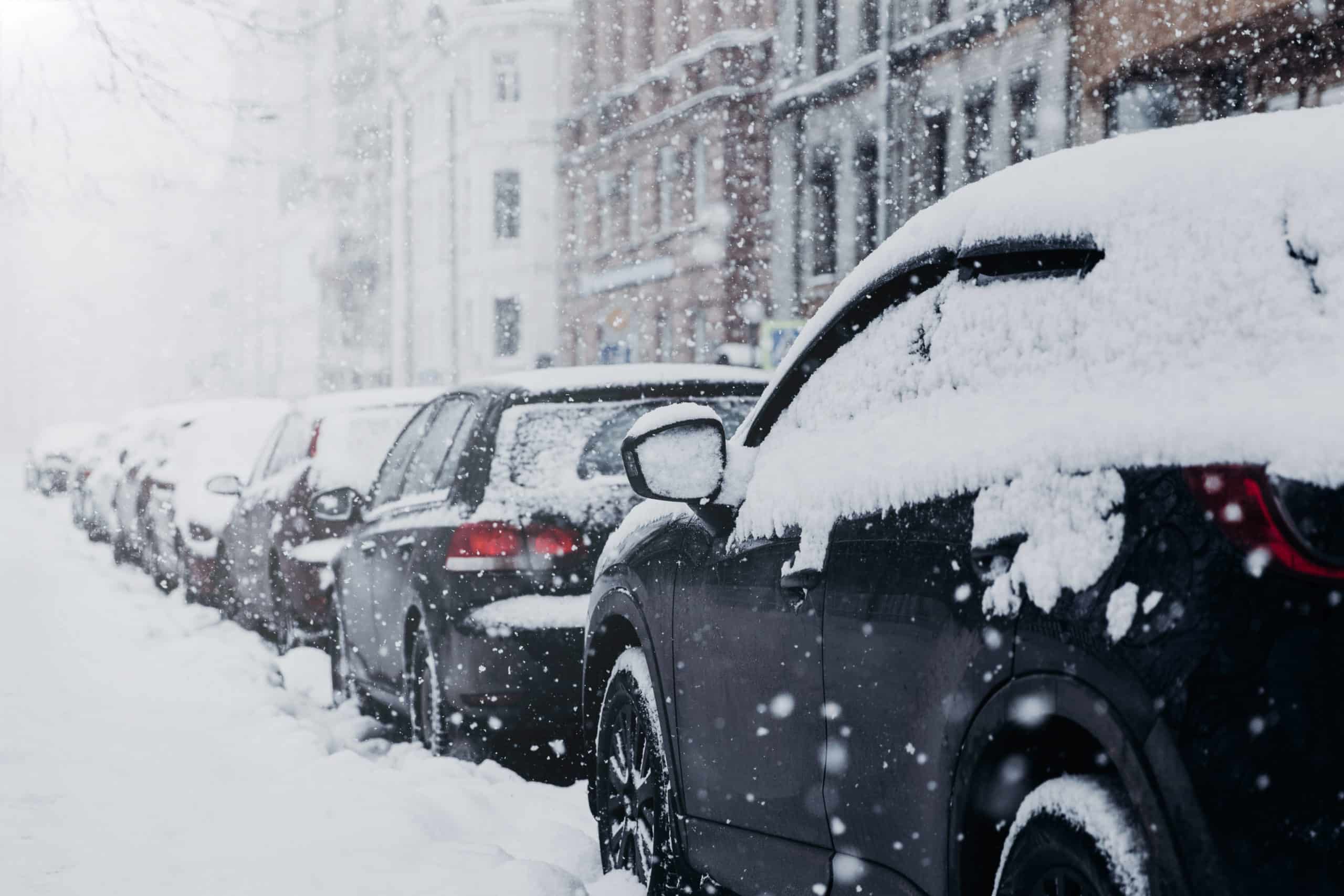 Snow covered city and cars